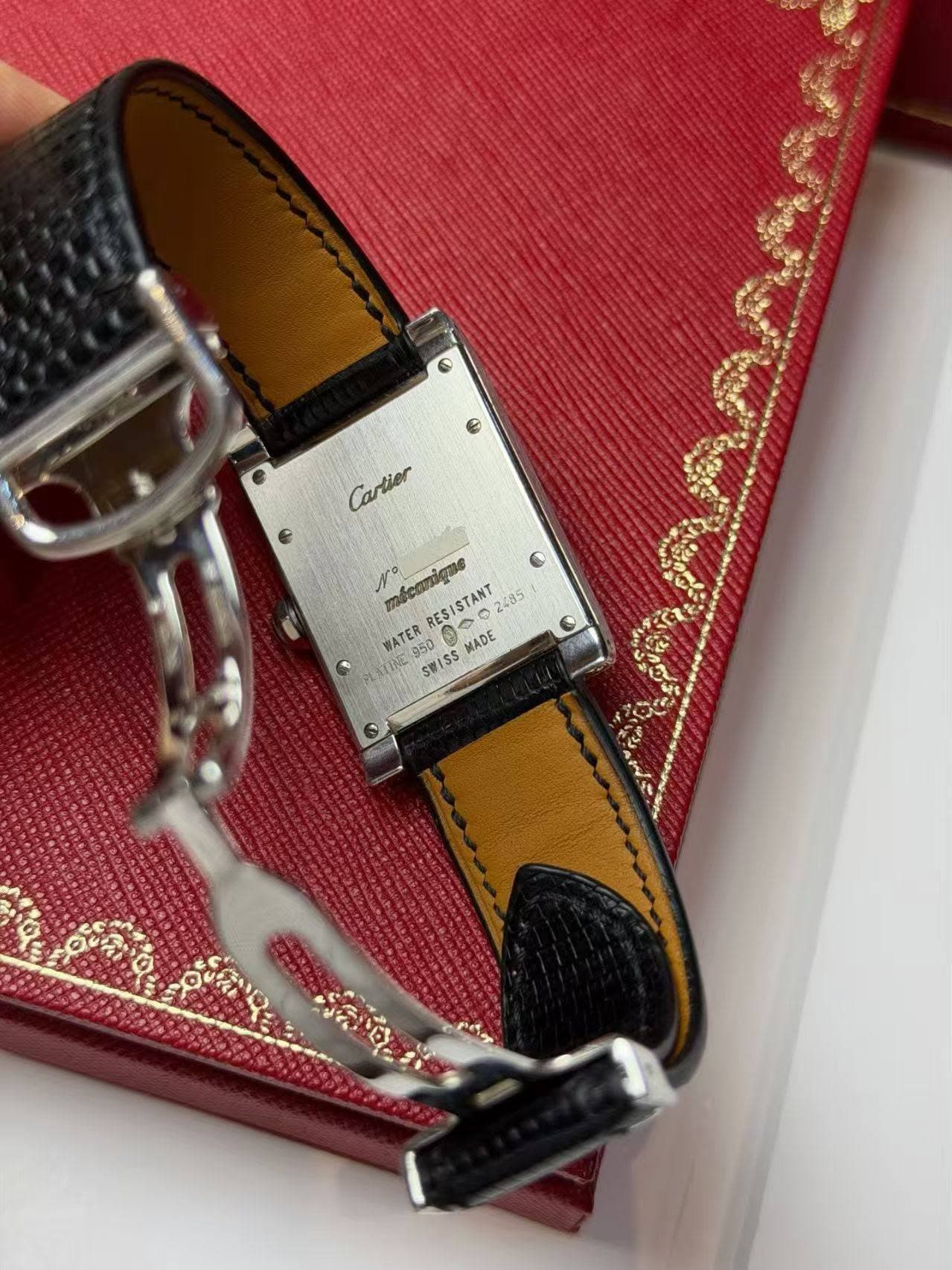 May be an image of leather wallet, saddle-stitched leather, leather, wrist watch and text