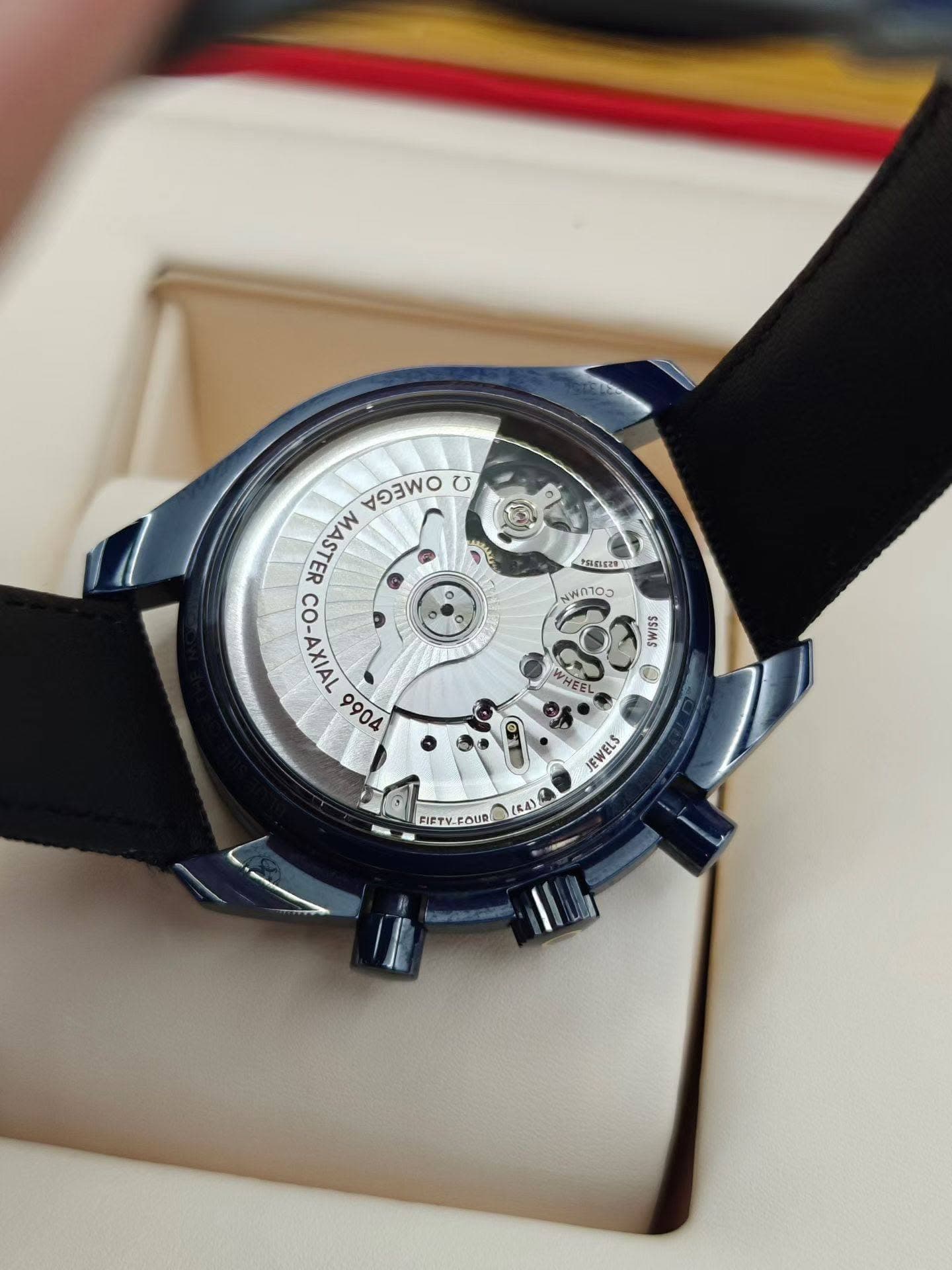 May be an image of wrist watch and text that says 'OBCA อ30 U S MASTER CO-AXIAL 9904 ٥ PELELEZON 01O0 SWISS WHEEL 6 EWELS FIETY-FOUR 1641'