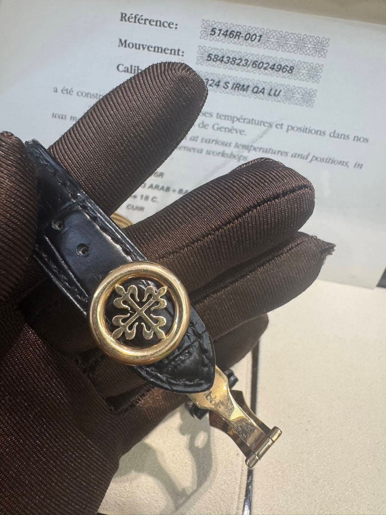 May be an image of cufflinks, wrist watch and leather