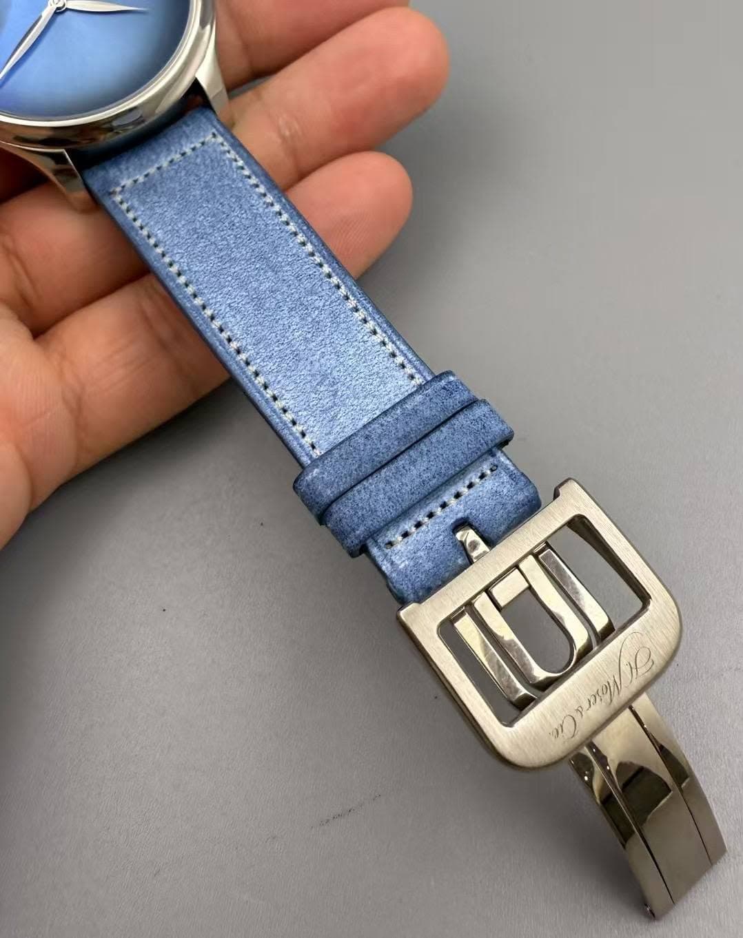 May be an image of leather, wrist watch and text