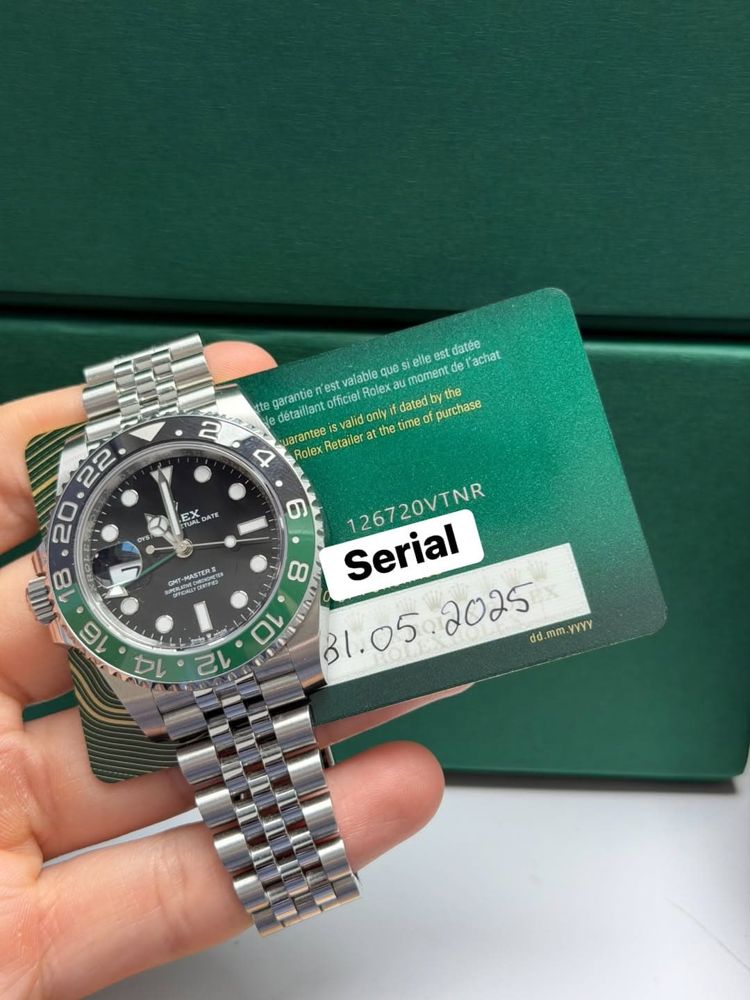 May be an image of wrist watch and text that says '2 eile moment elle est လလန်မ datée l'achat est valable que au garantie officiel Rolex détaillant arantee valid R Rolex Retailer…