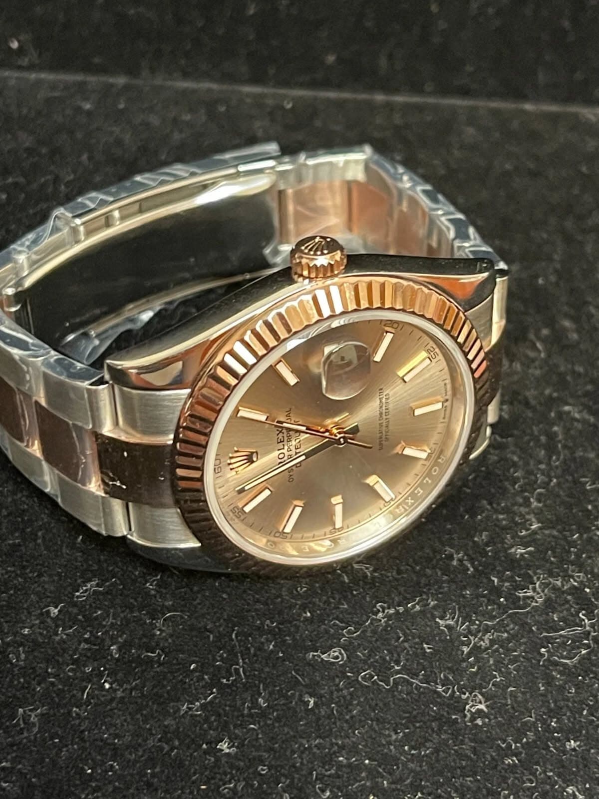 May be an image of wrist watch and text