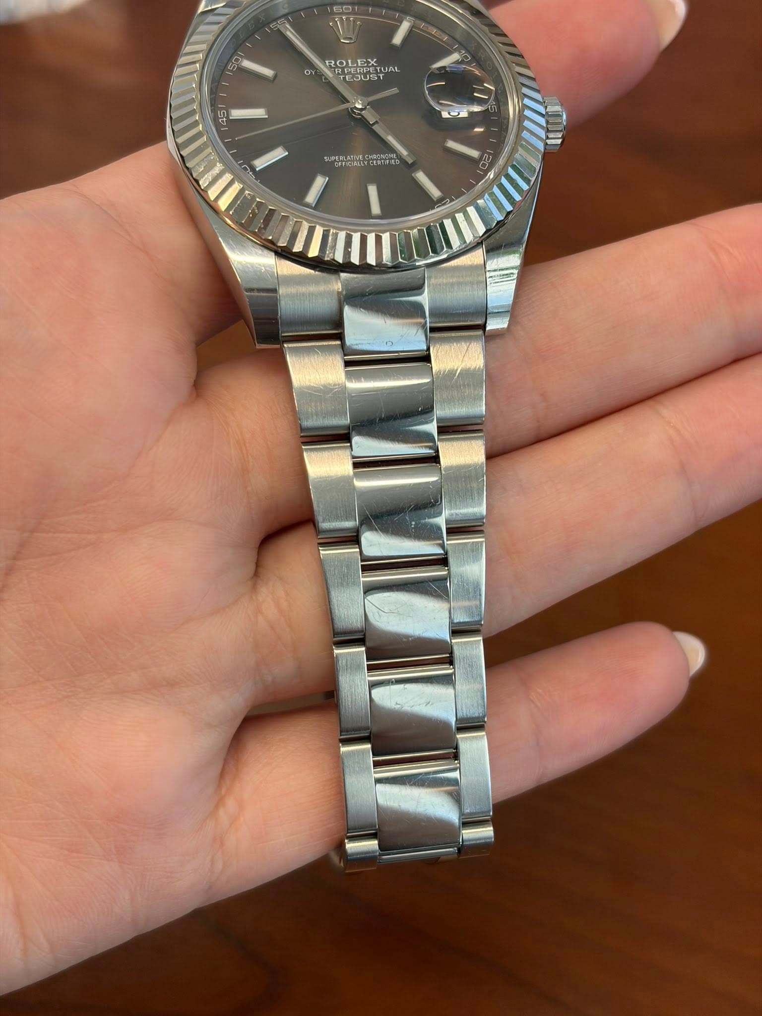 May be an image of wrist watch and text