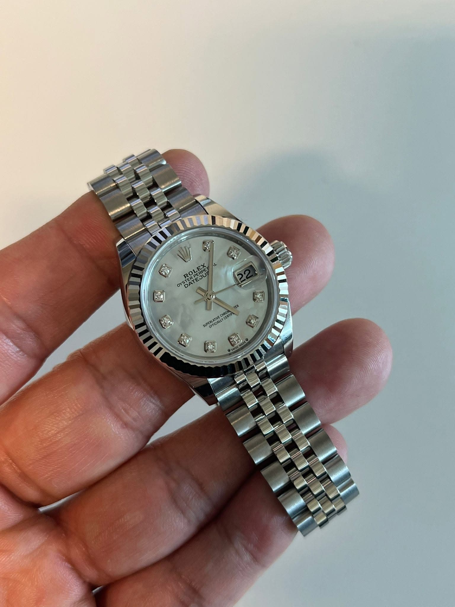 May be an image of wrist watch and text