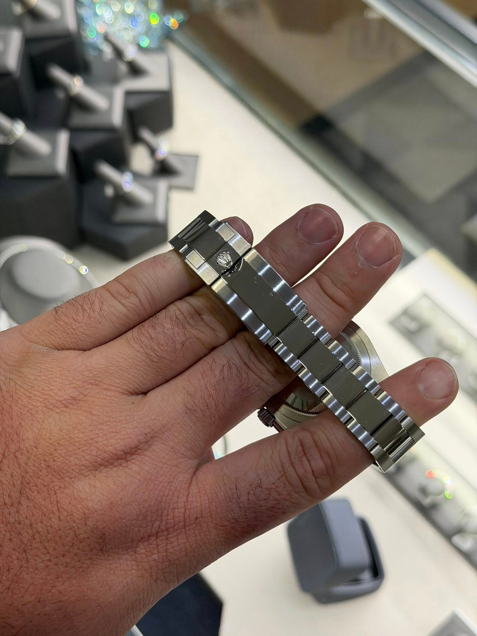 May be an image of wrist watch, ring and text