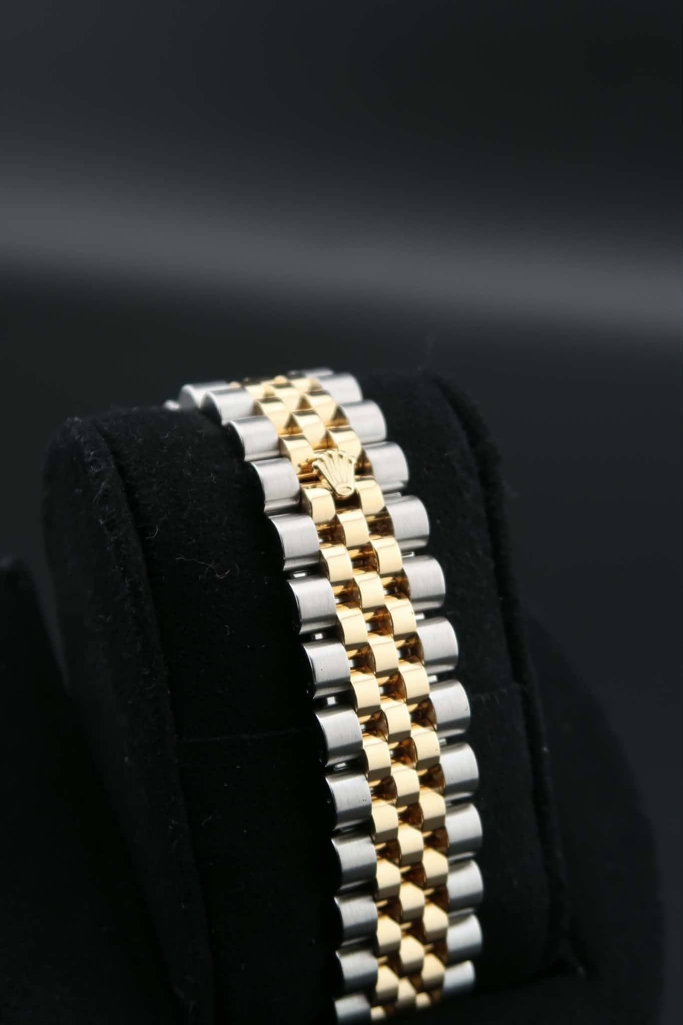 May be an image of wrist watch and jewelry