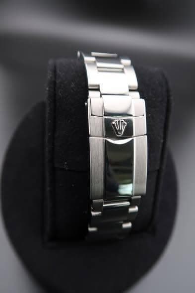 May be an image of digital watch, jewelry and text