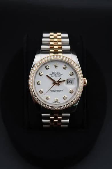 May be an image of wrist watch and text