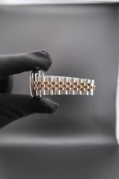 May be an image of wrist watch and jewelry