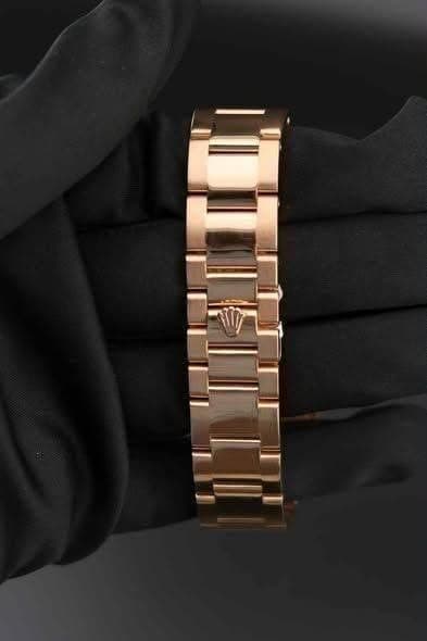 May be an image of wrist watch and jewelry