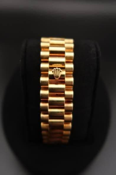 May be an image of wrist watch, jewelry and text
