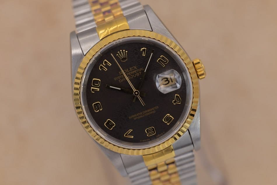 May be an image of wrist watch and text