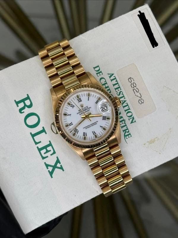 May be an image of wrist watch and text