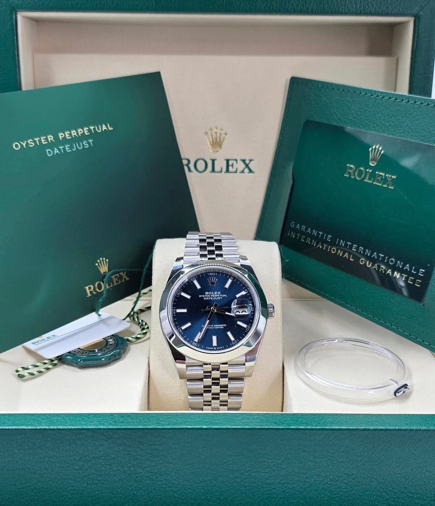 May be an image of wrist watch and text that says 'OYSTERPERNUETUAL OYSTER DATEJUST PERPETUAL ROLEX RO ROLEX NN M C بي IONAL GUARANTE INTERNATIONALE GUARA UNN'