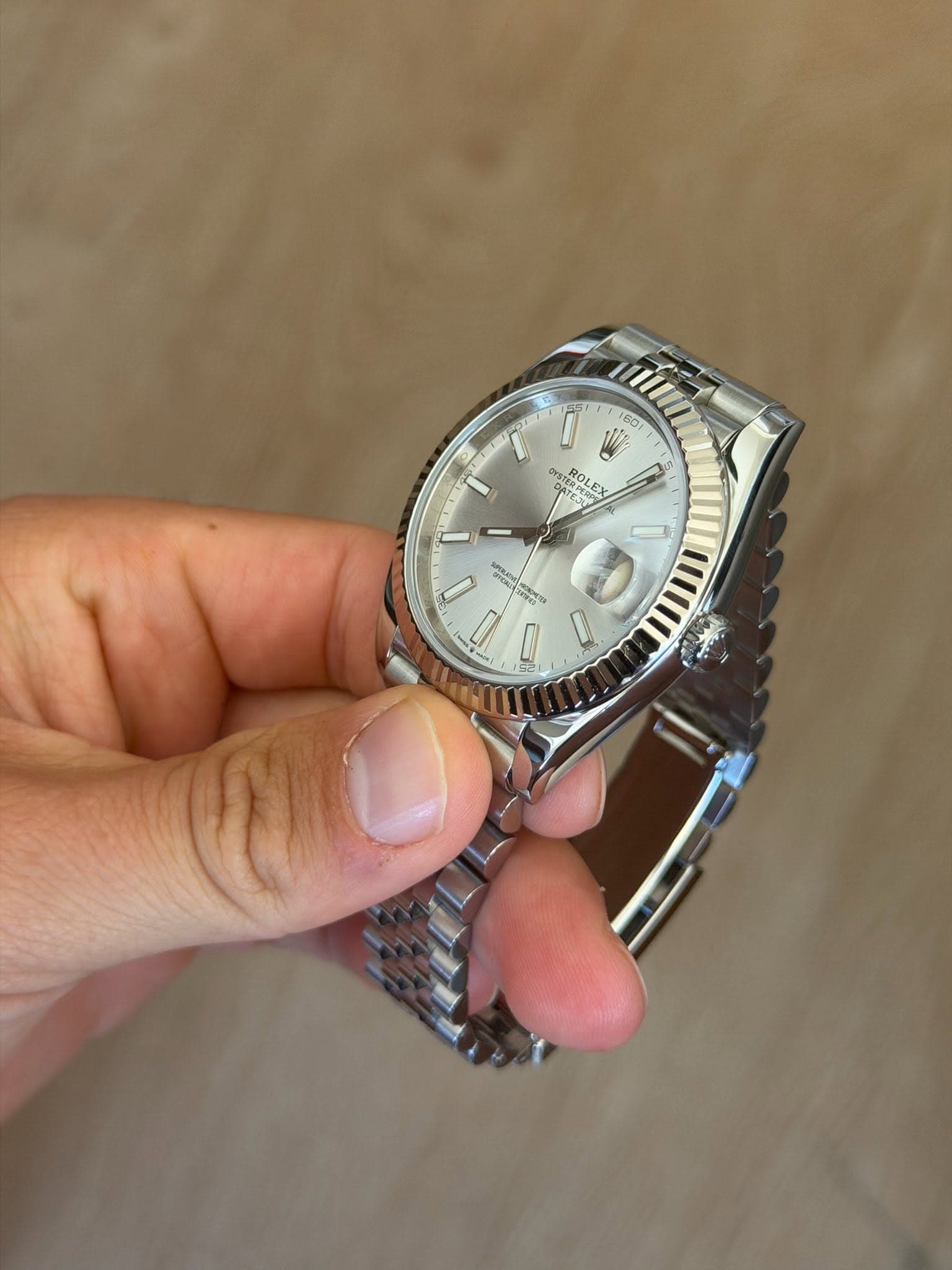 May be an image of wrist watch and text