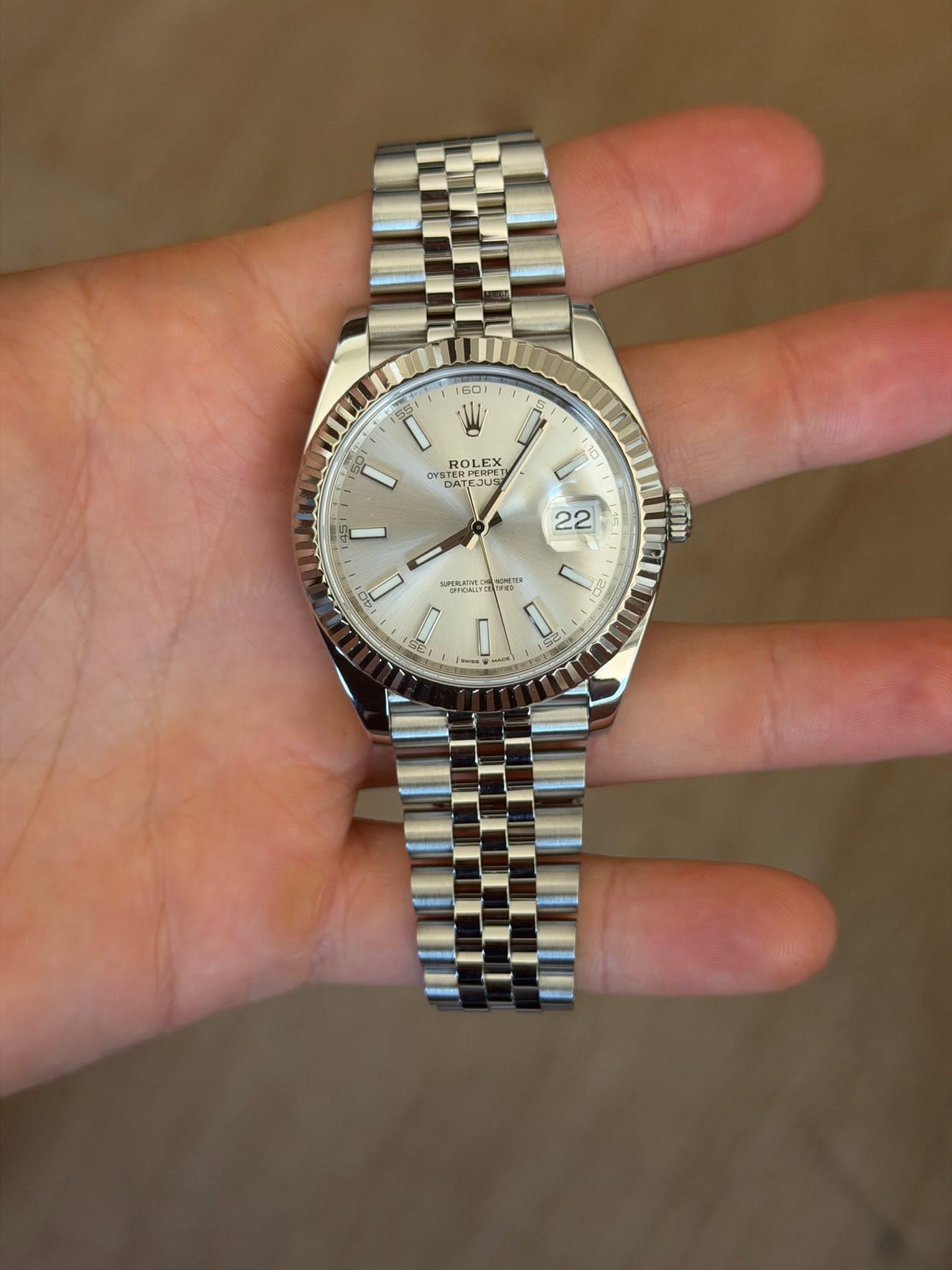 May be an image of wrist watch and text
