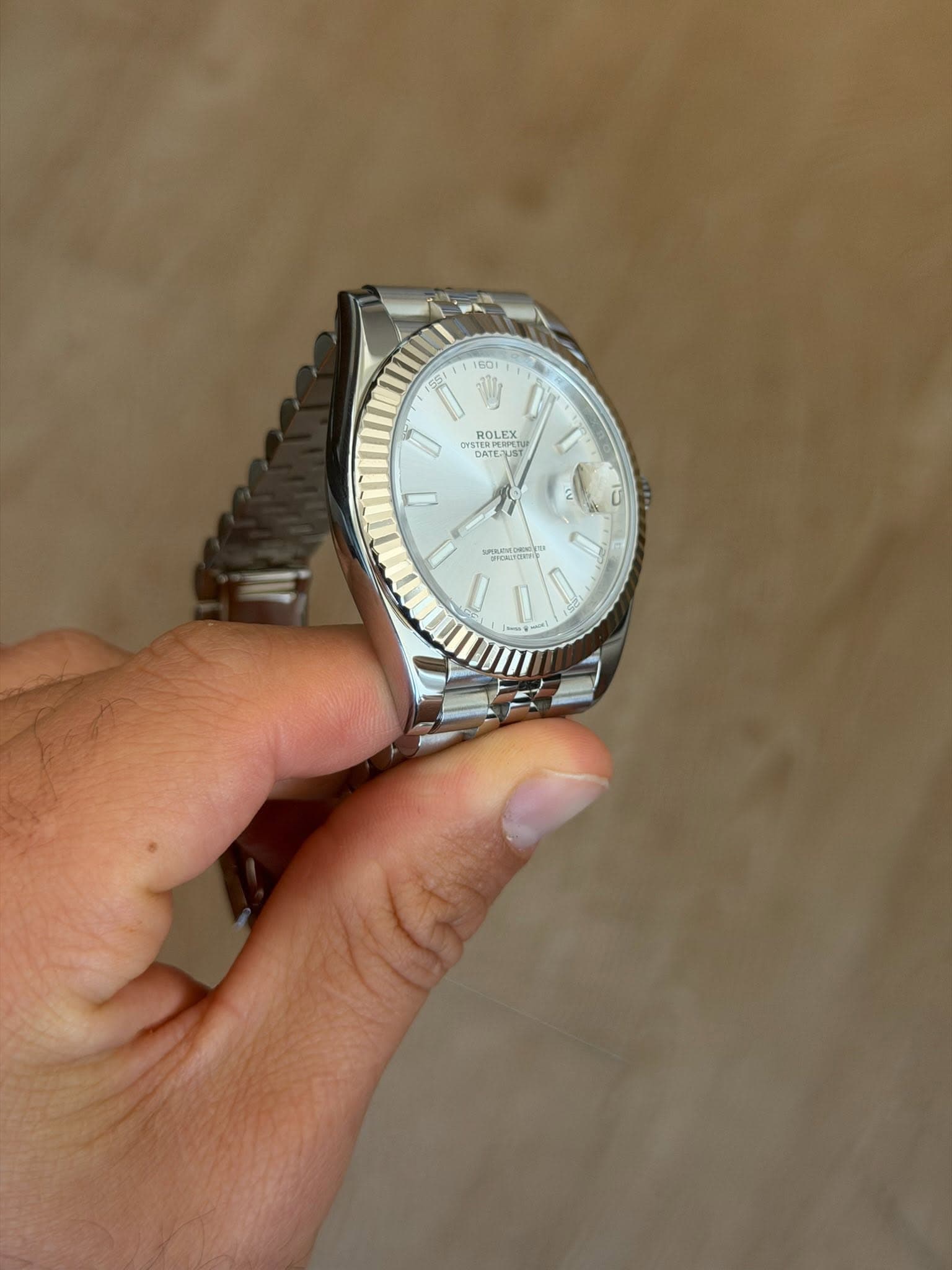 May be an image of wrist watch and text
