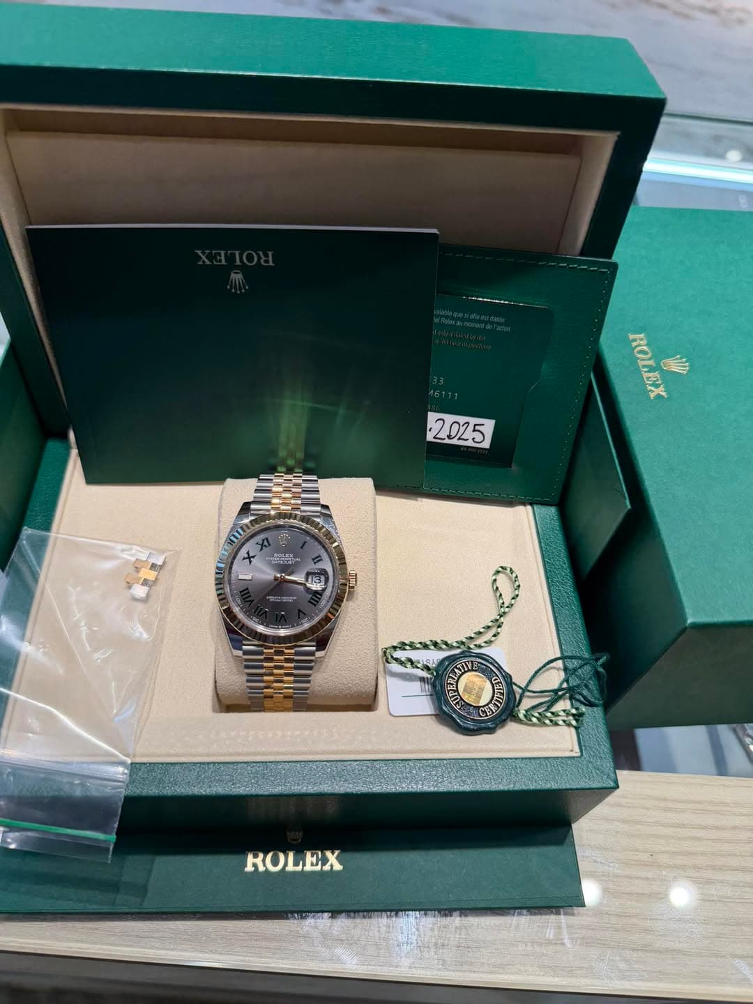 May be an image of wrist watch and text that says 'ROLEX OBHX ill 2025 SEE 1S ROLEX'