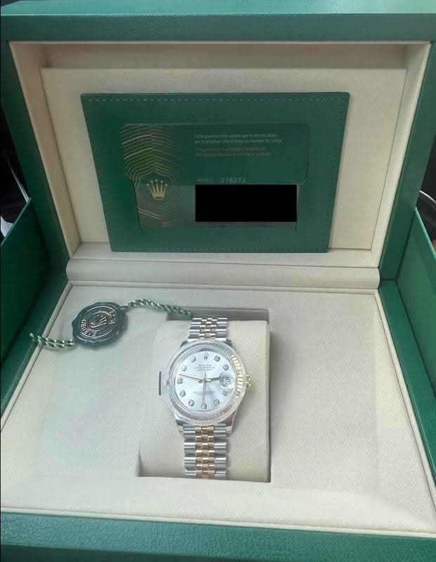 May be an image of wrist watch and text