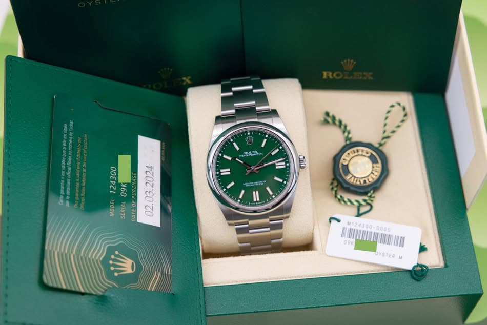 May be an image of wrist watch and text that says 'Rolexaumpment ROLEK II 面 mee aが 124300 09K MODEL SERIAL DATEOF DATE 02.03. ጣ M124300-0005 BJIUMUMIN M1245 09K OYSTER'