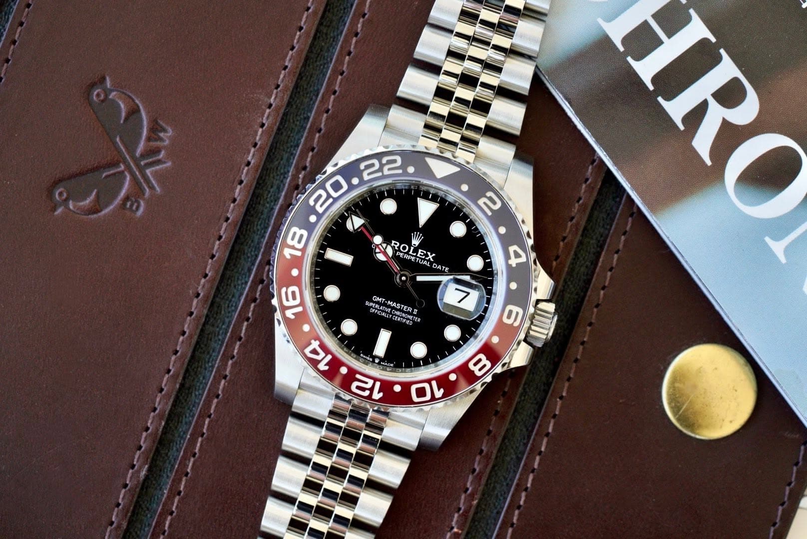 May be an image of wrist watch and text that says ' ROL ROL OLEX PETUM TRPC RPET TUAL JAL EX ATE L GMT S RAEONON द्গशन CERTFEO -MASTERE MAST RO VNII 8 0'