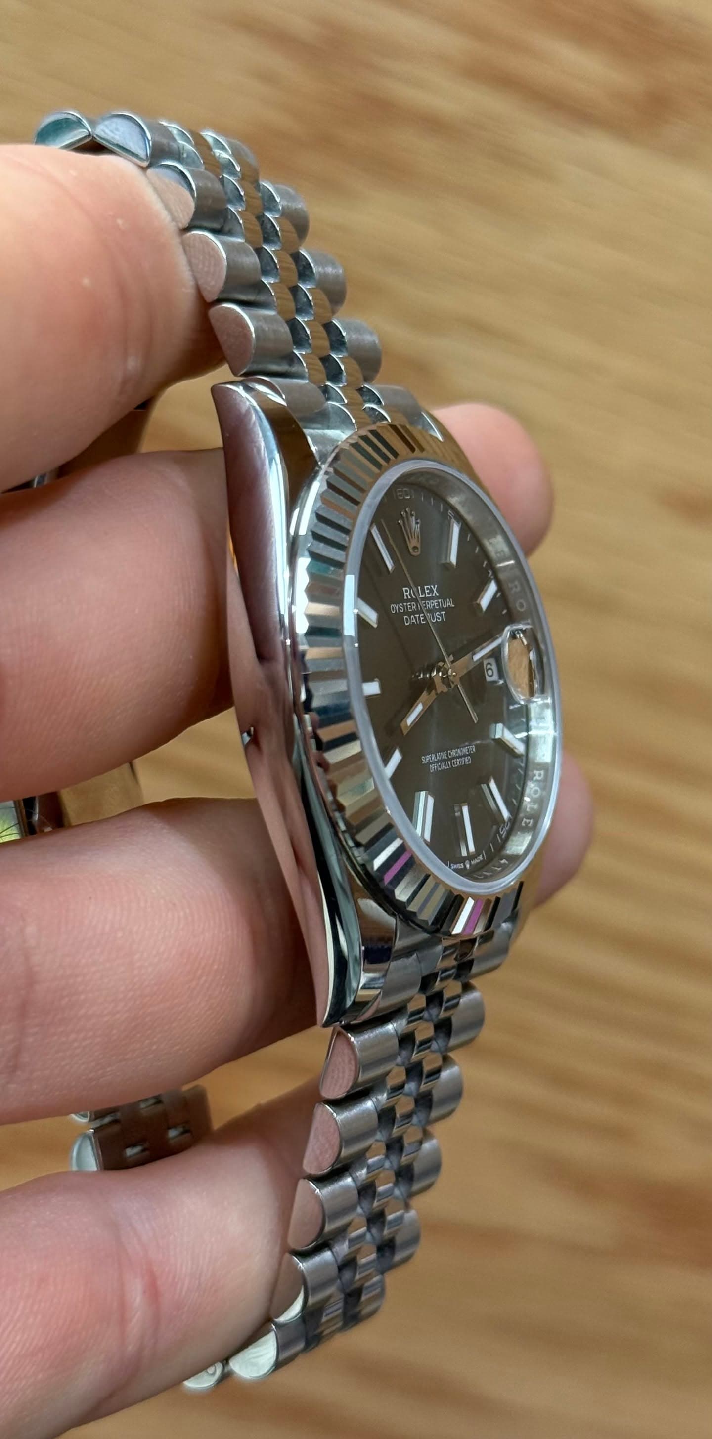 May be an image of wrist watch and text
