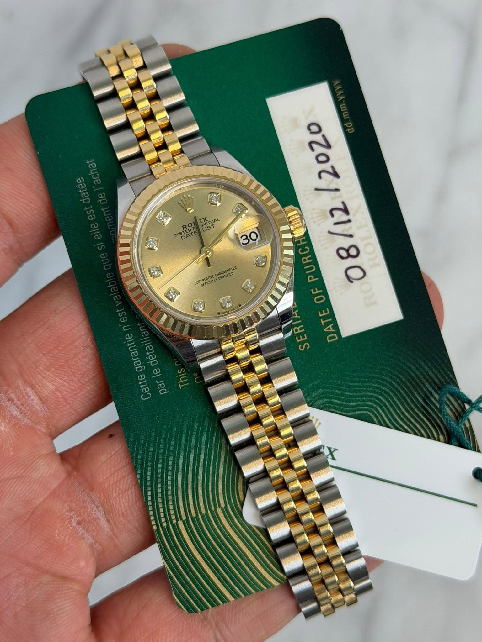 May be an image of wrist watch and text