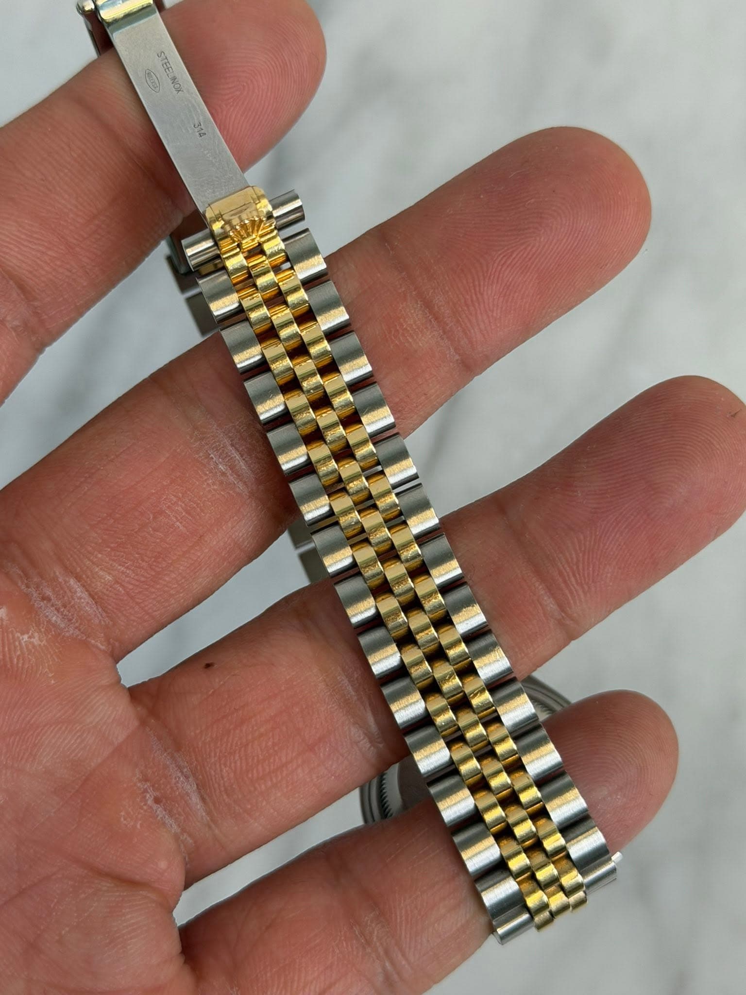 May be an image of wrist watch and text that says 'E'
