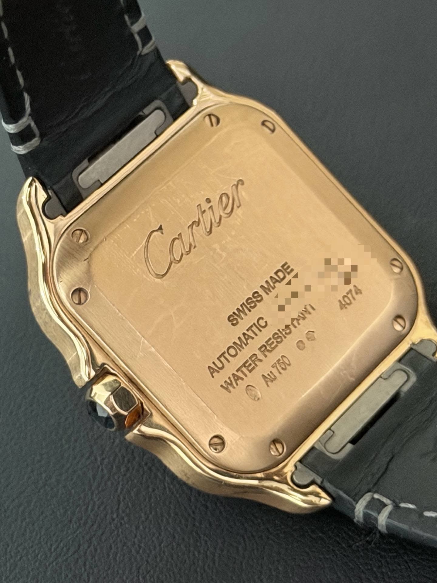 May be an image of wrist watch and text that says 'e Cartier SWISS SWISSMADE MADE SWISS RRESISMN 4074 AUTOMATIC WATERRESIOAON RESISTANI 一今 の Au75000 ٢ ® WATER Au750 2 2'