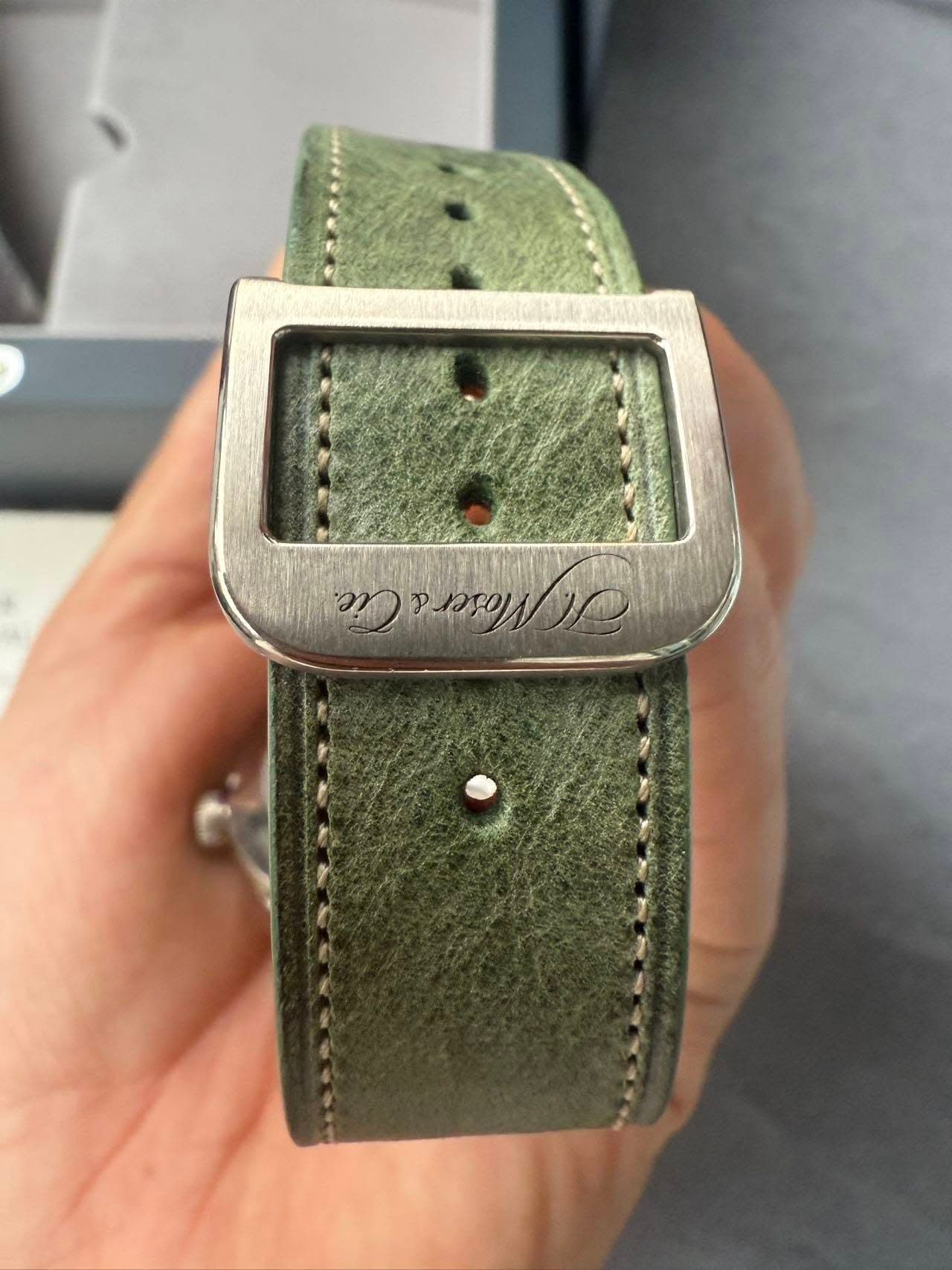 May be an image of saddle-stitched leather and wrist watch