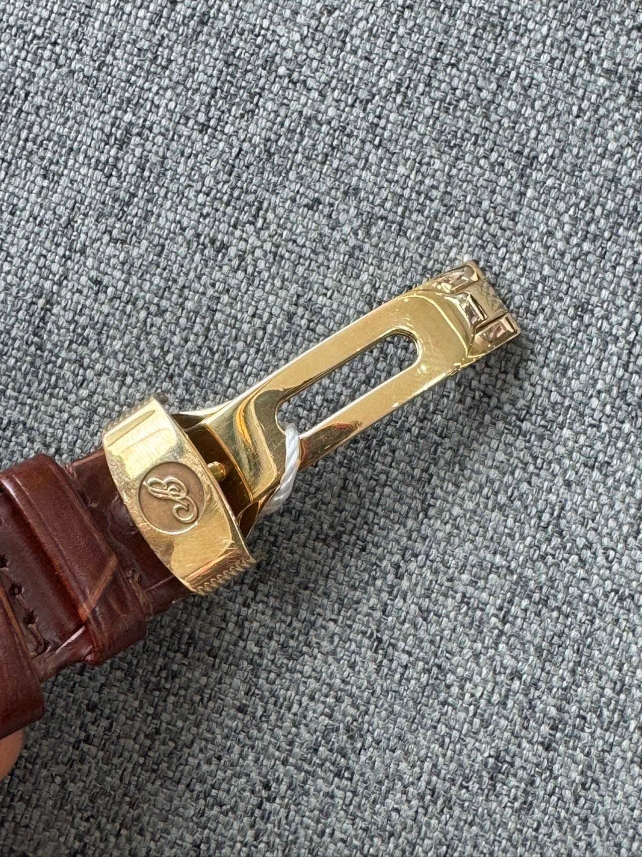 May be an image of brass and wrist watch