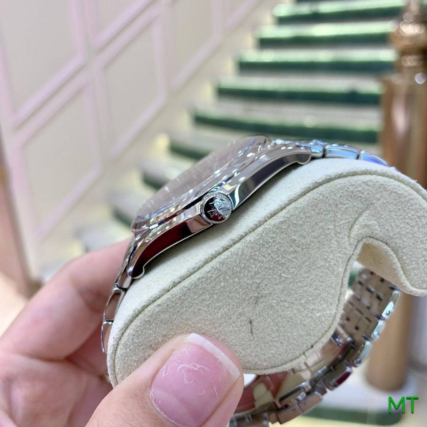May be an image of wrist watch, ring and text that says 'MT'