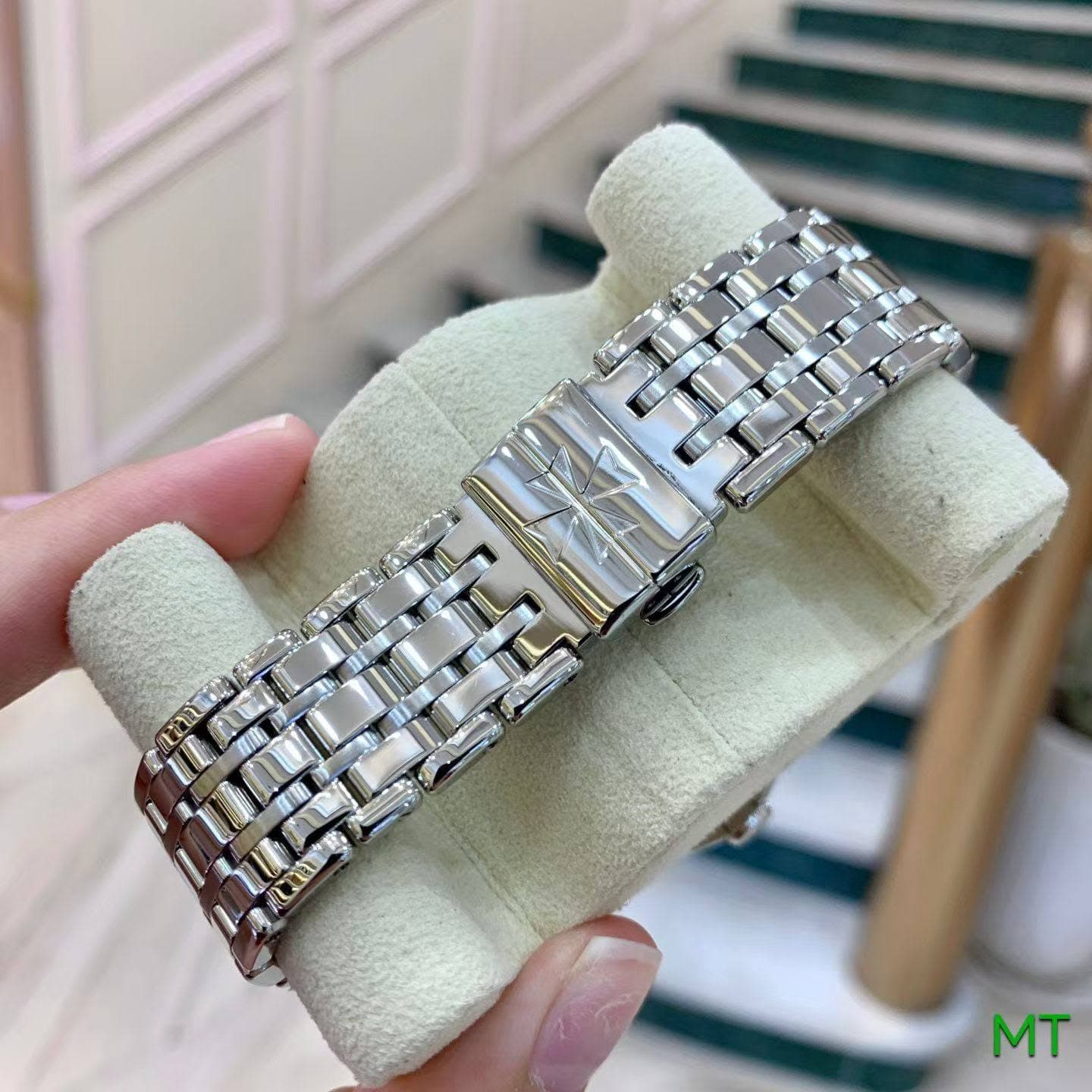 May be an image of jewelry, wrist watch and text