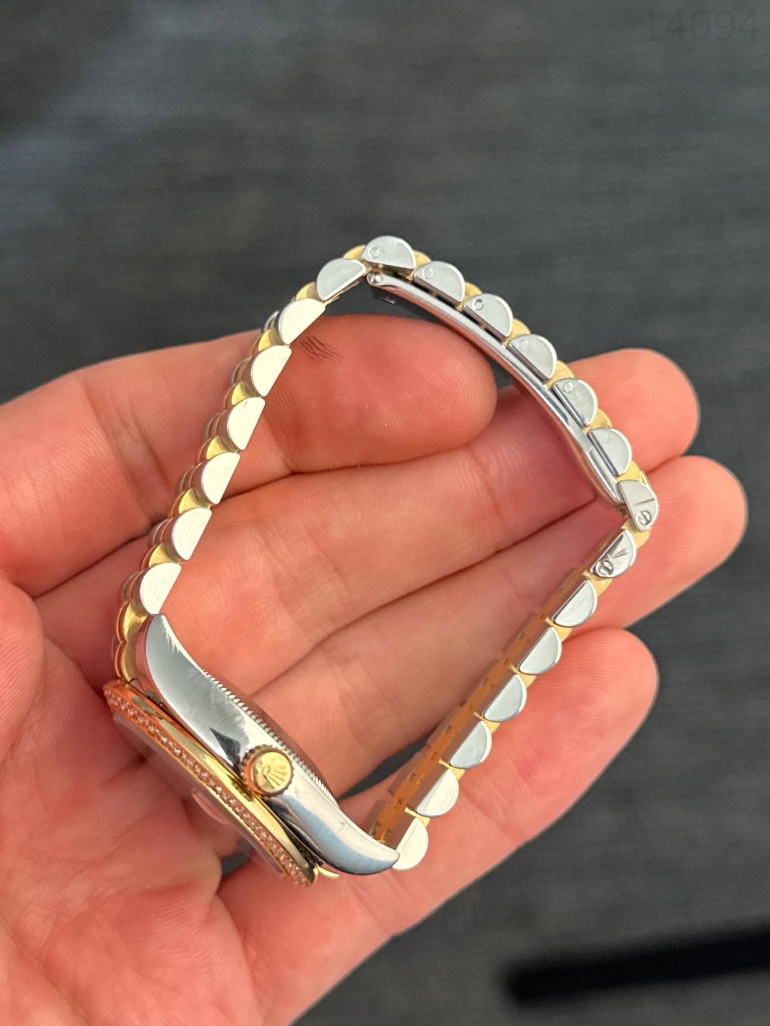 May be an image of wrist watch and jewelry