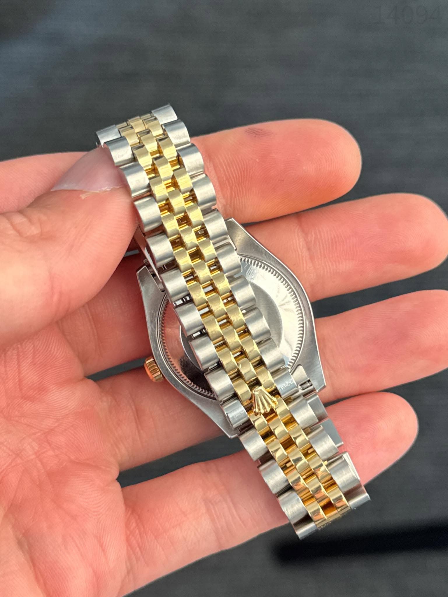 May be an image of wrist watch and text