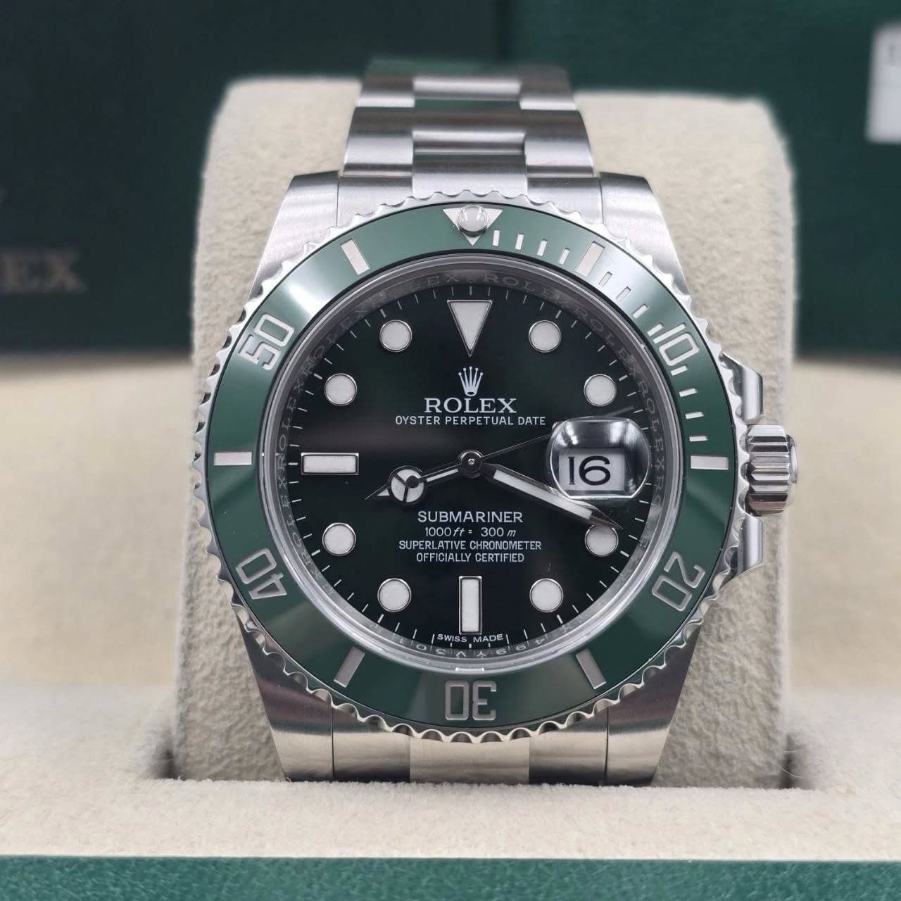 May be an image of wrist watch and text that says '50 ROLEX OYSTER PERPE ERPETUA TUA TUALDAI UAL JAL DATE 10 16 SUBMARINER ១០០០- UDORGBETE CHRONOMETER SUPERLATIVE.CHRCHOMETER TER…