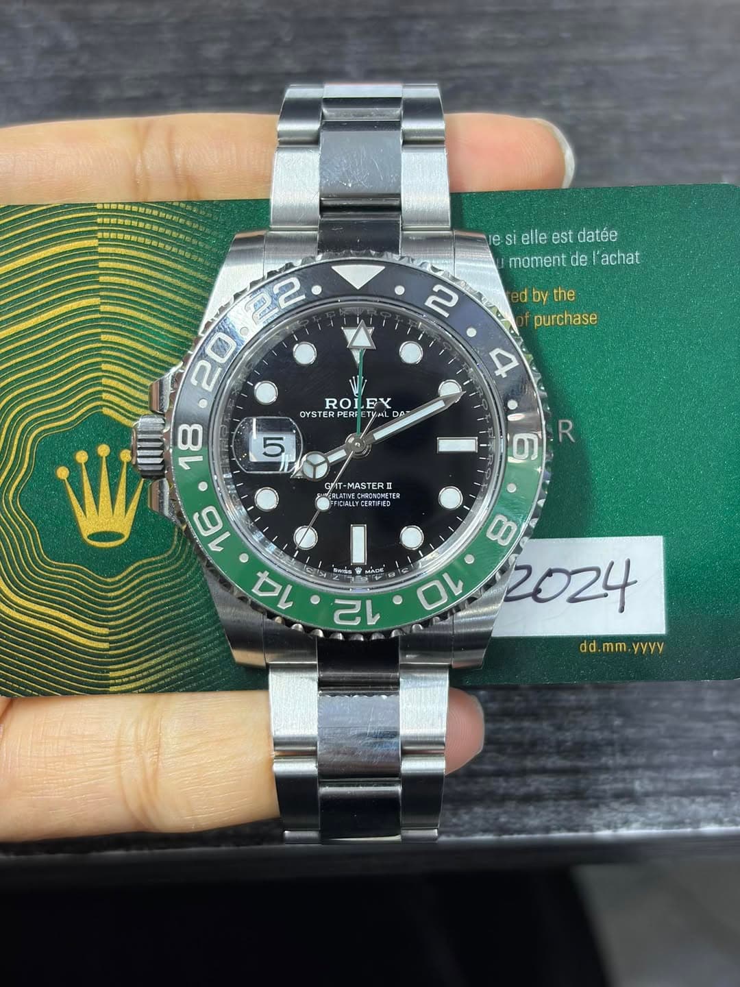 May be an image of wrist watch and text that says 'esiellestdatée es si elle est datée moment de 'achat 勝 2 2 d by the purchase 4 ROLFY LEY ROI OYSTER 5 Op RE 然崎 00 18 5…