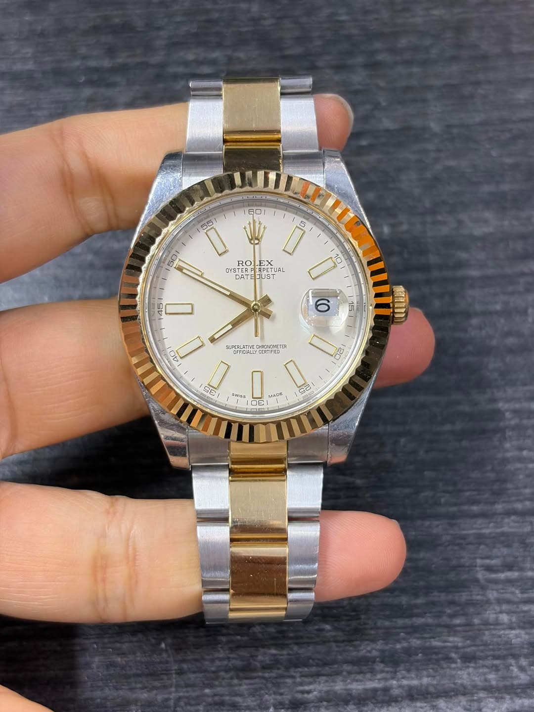 May be an image of wrist watch and text