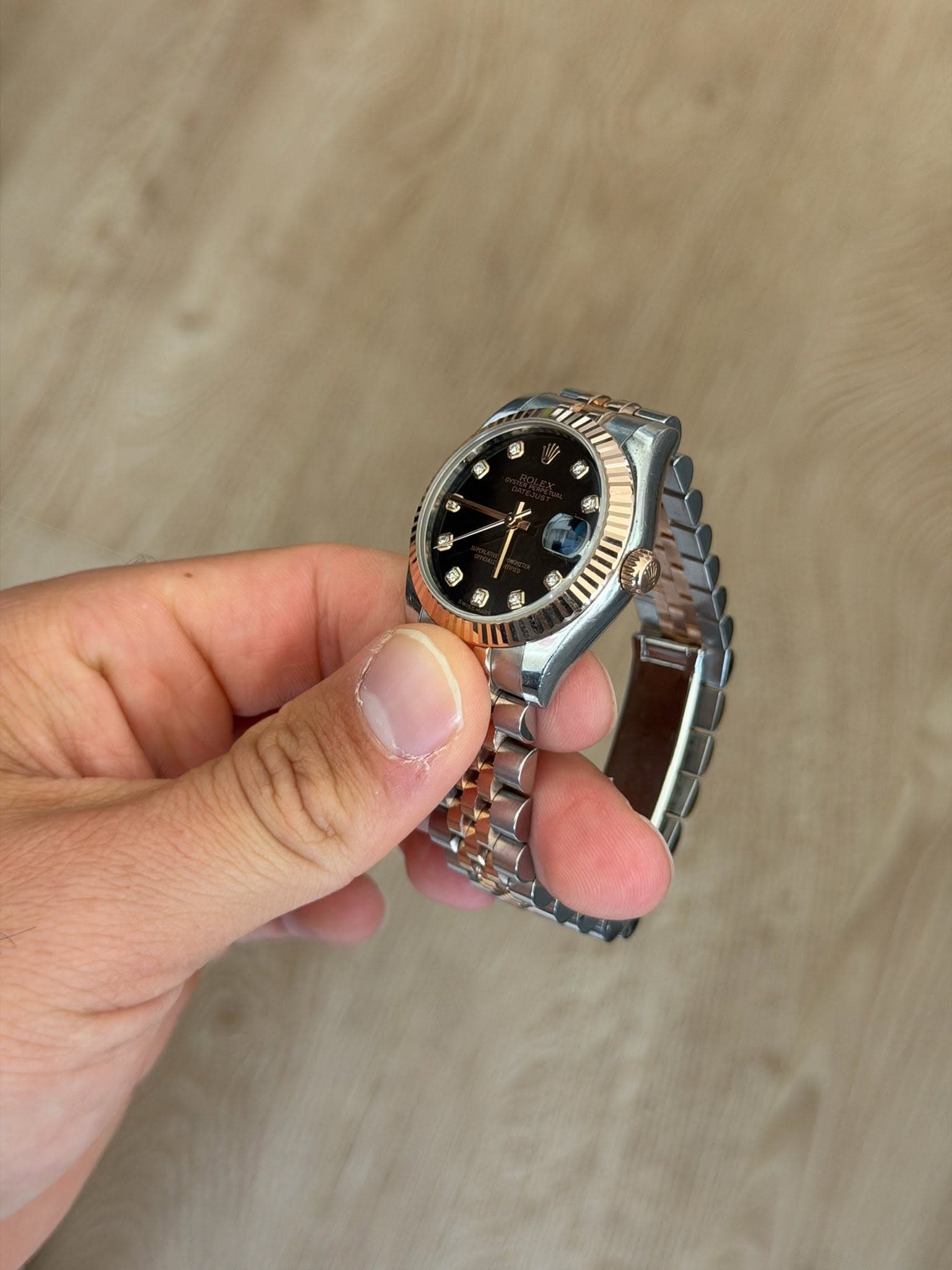 May be an image of wrist watch and text