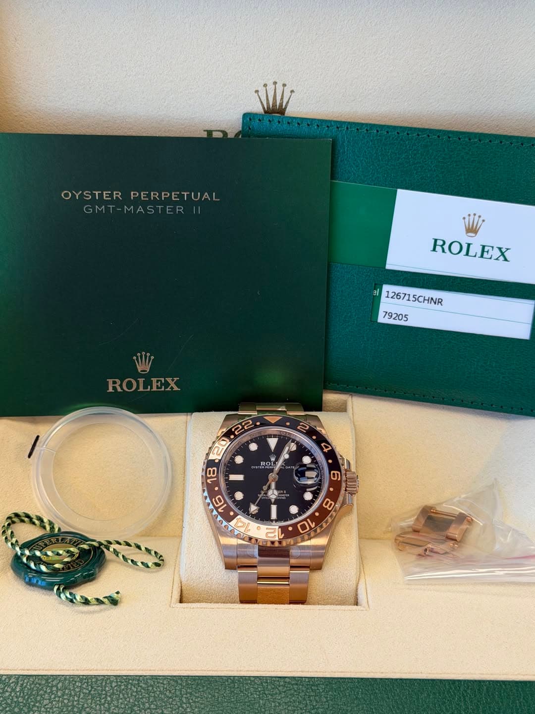 May be an image of wrist watch and text that says 'OYSTERPERPETUAL OYSTER PERPETUAL GMT-MASTER| GM -MASTE ROLEX 126715CHNR 79205 W ROLEX EX ROI T ROL OL ស 10'