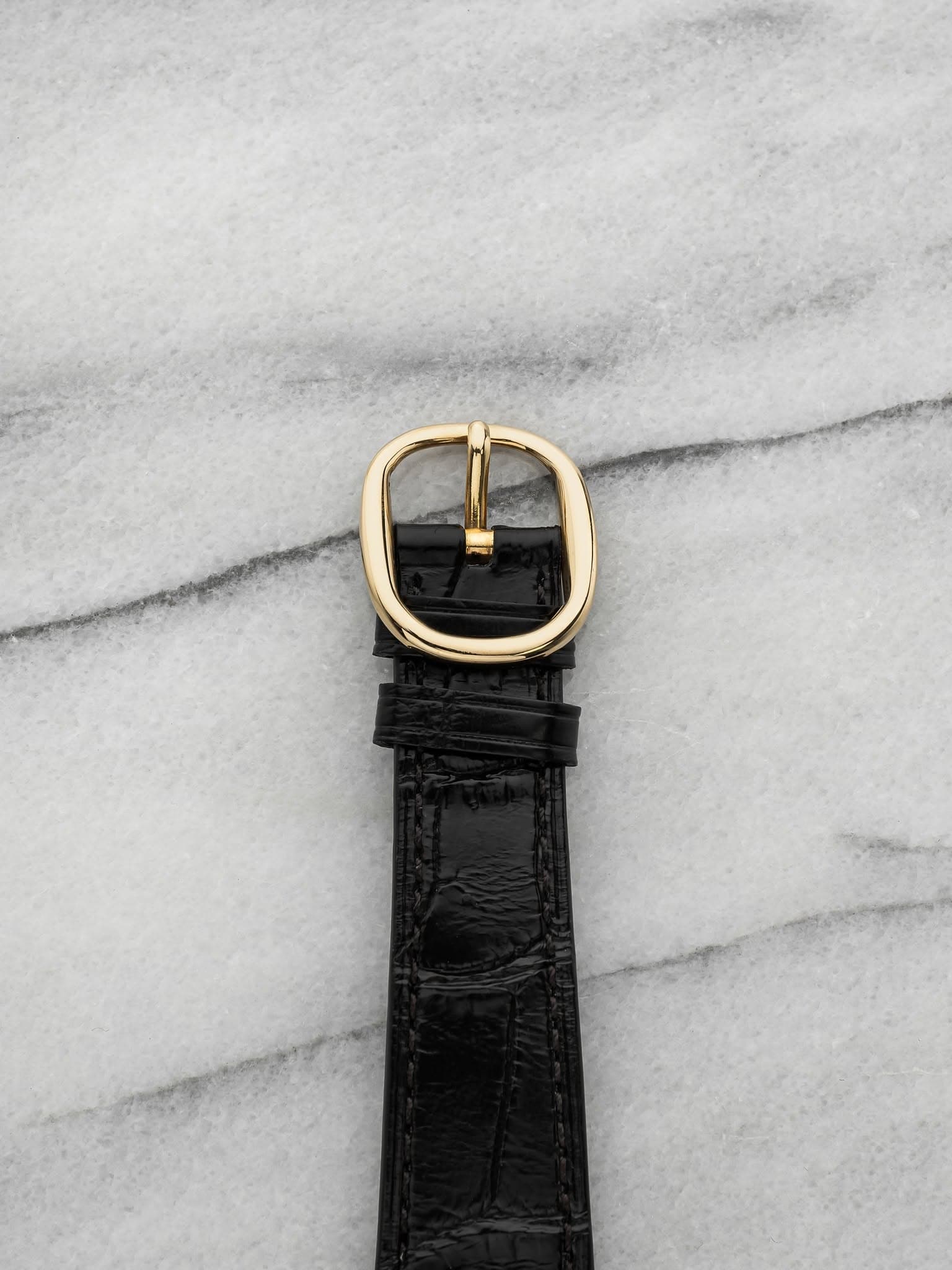May be an image of wrist watch, leather and saddle-stitched leather