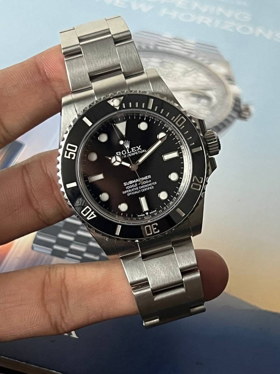 May be an image of wrist watch and text that says '10 50 RO ROLEX 01 ERPE LEX ETUAL UAL SUBMAPINER SUEMAI 1000/ PA GFFICIALLYC CEROED 10000= SUBMAP PINER TR SIDENLA -L חס =3 N…