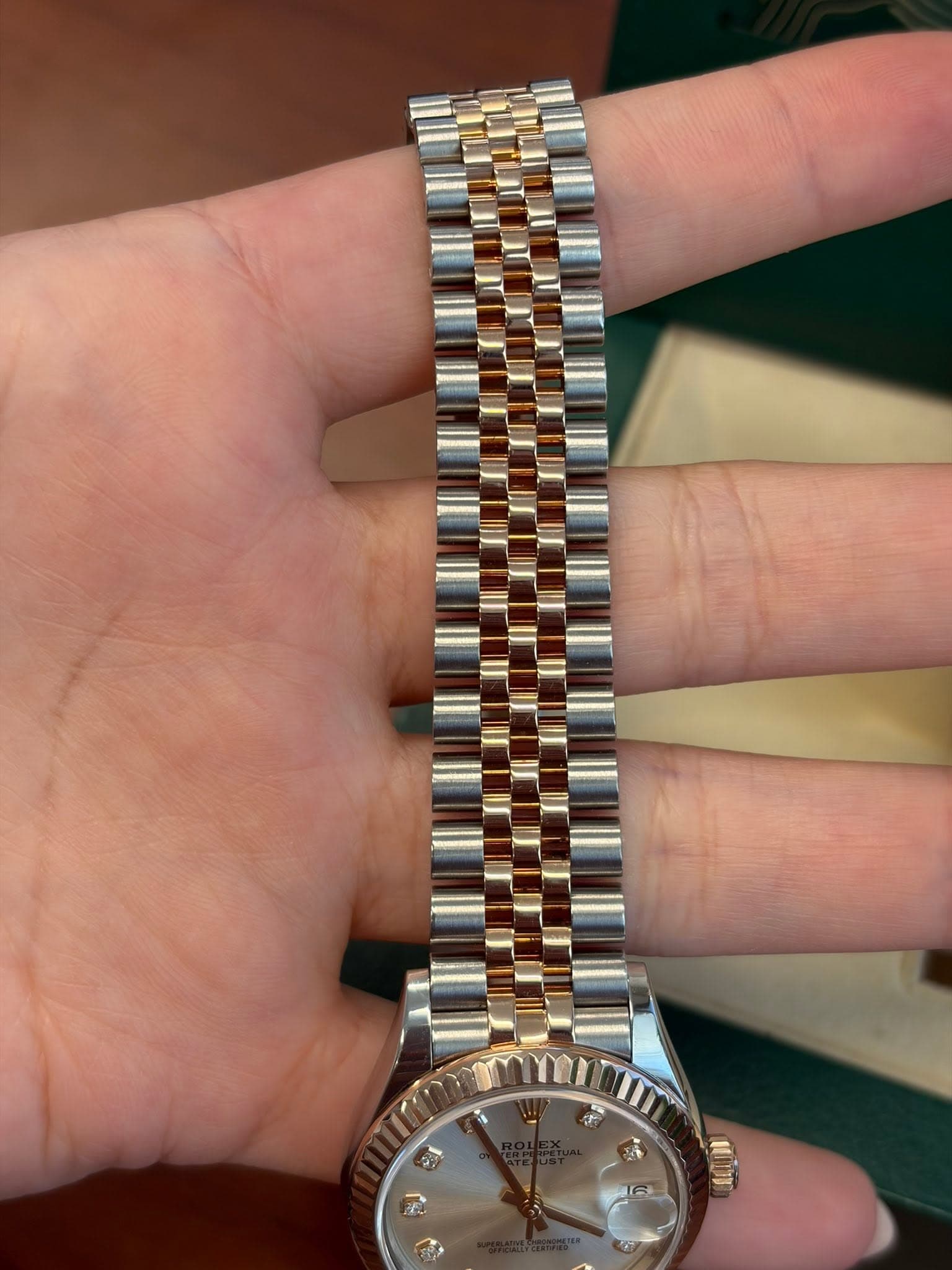 May be an image of wrist watch and text