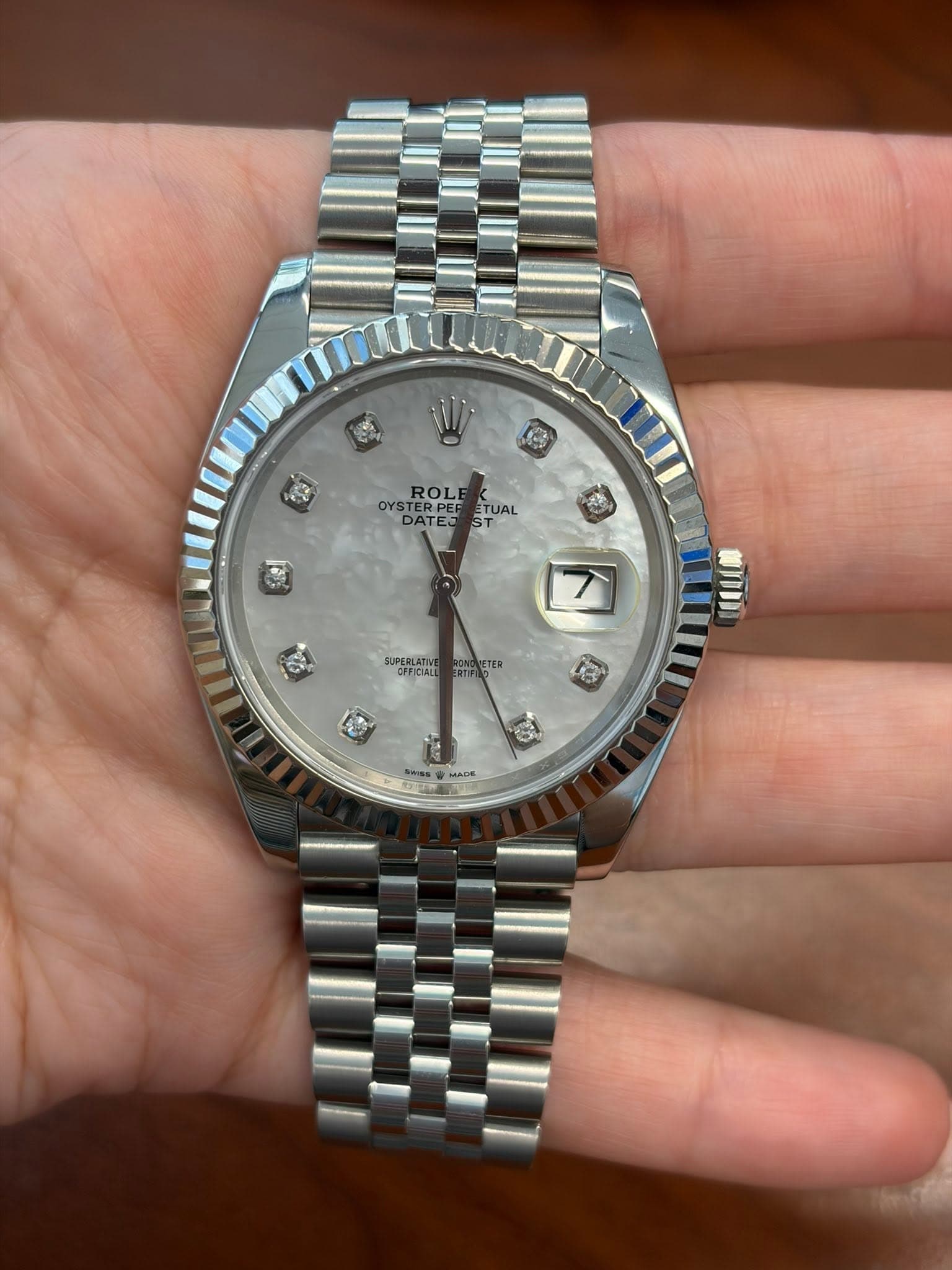 May be an image of wrist watch and text