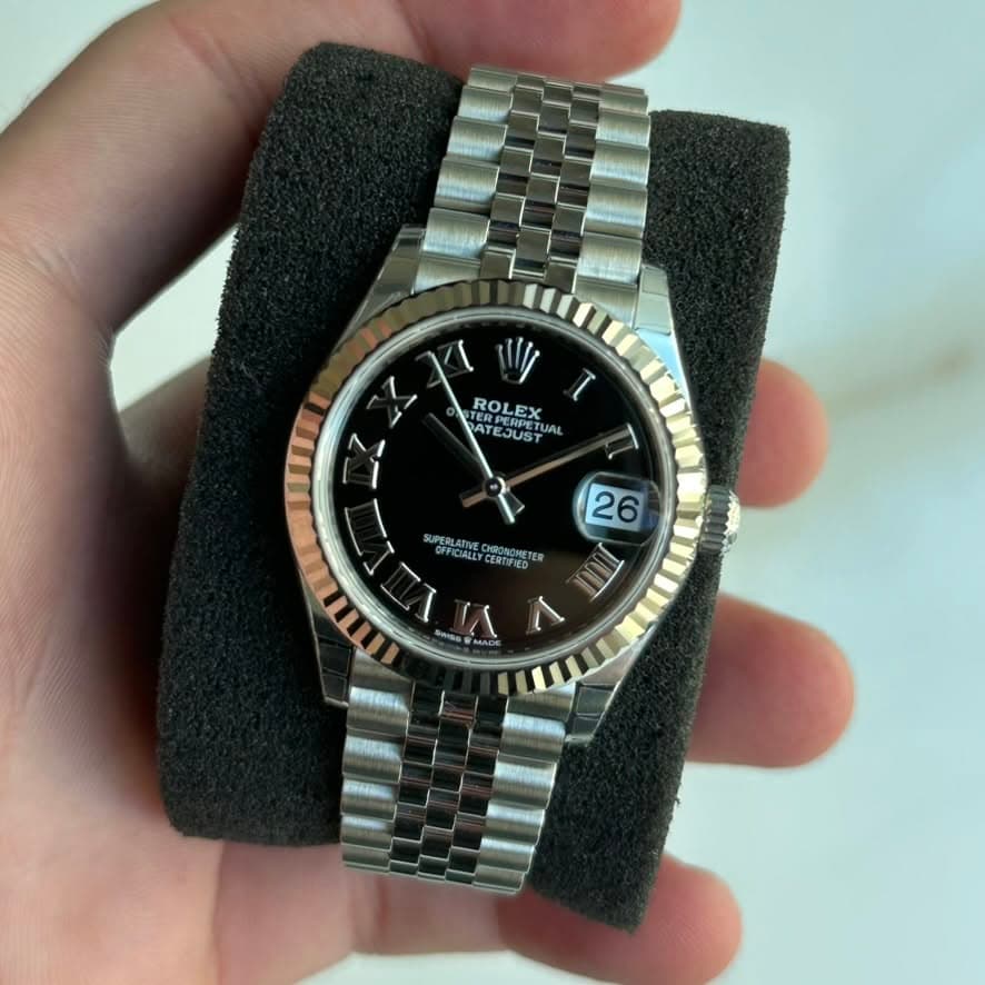 May be an image of wrist watch and text