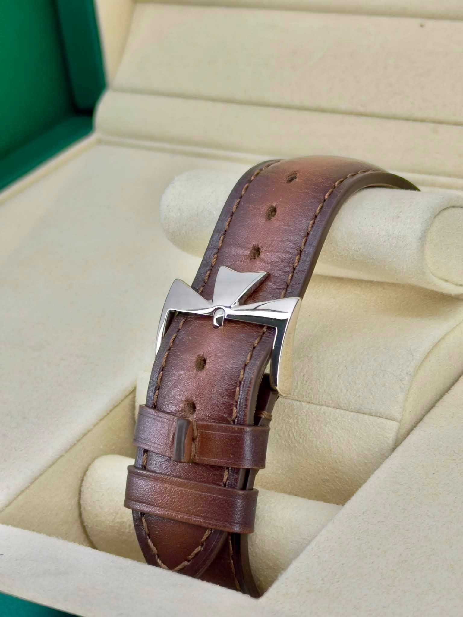 May be an image of leather, wrist watch, saddle-stitched leather and text