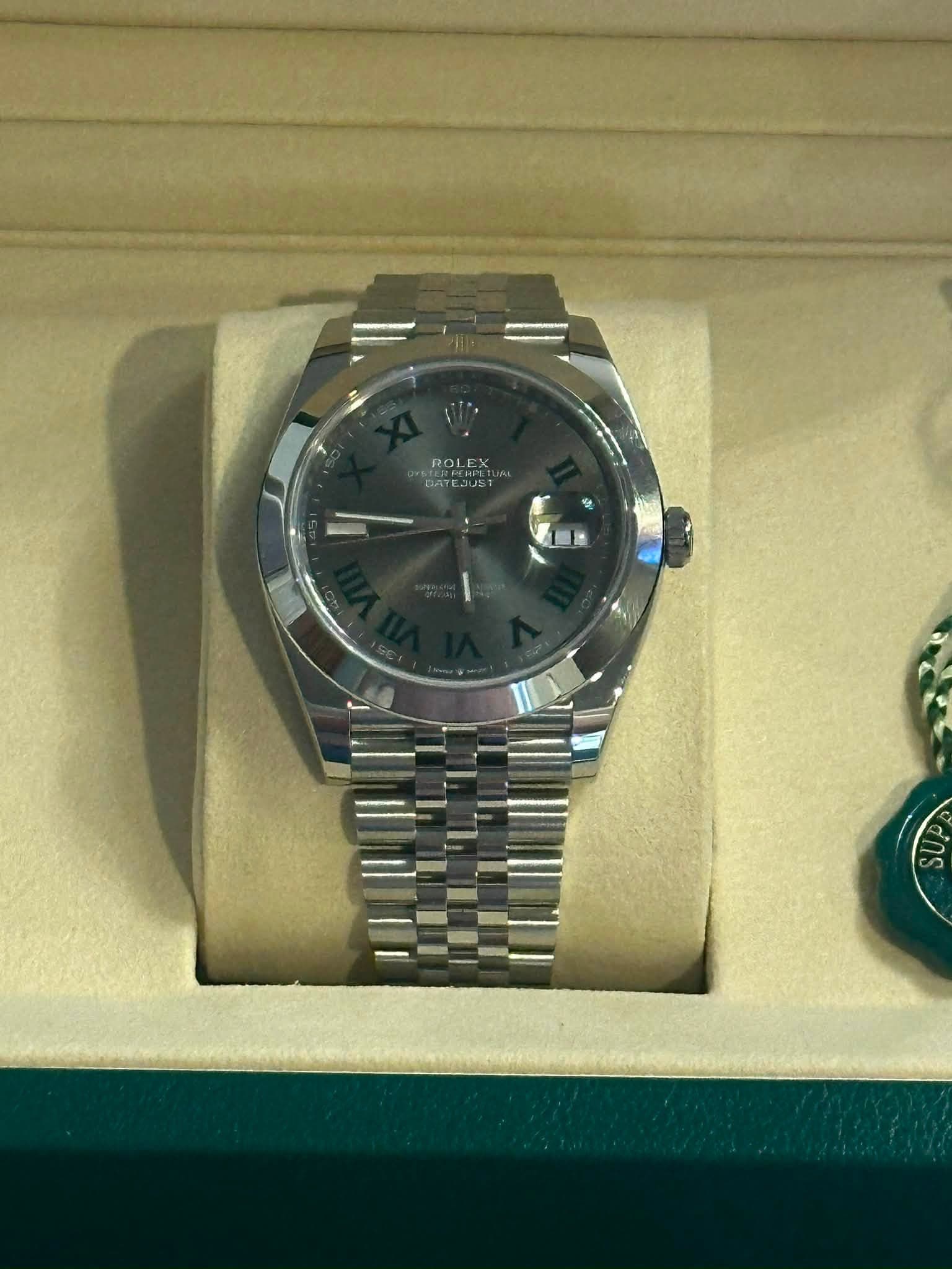 May be an image of wrist watch and text that says 'ROLEX'