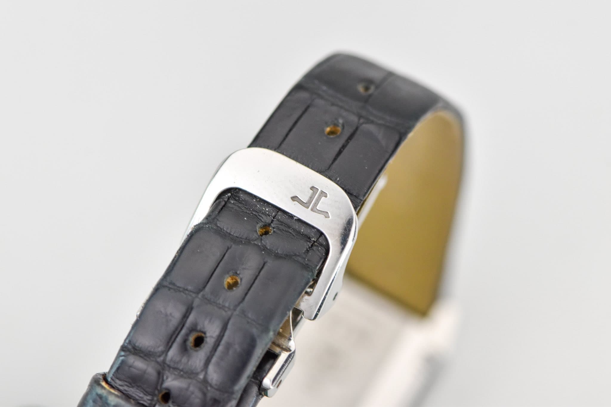 May be an image of wrist watch, leather and text