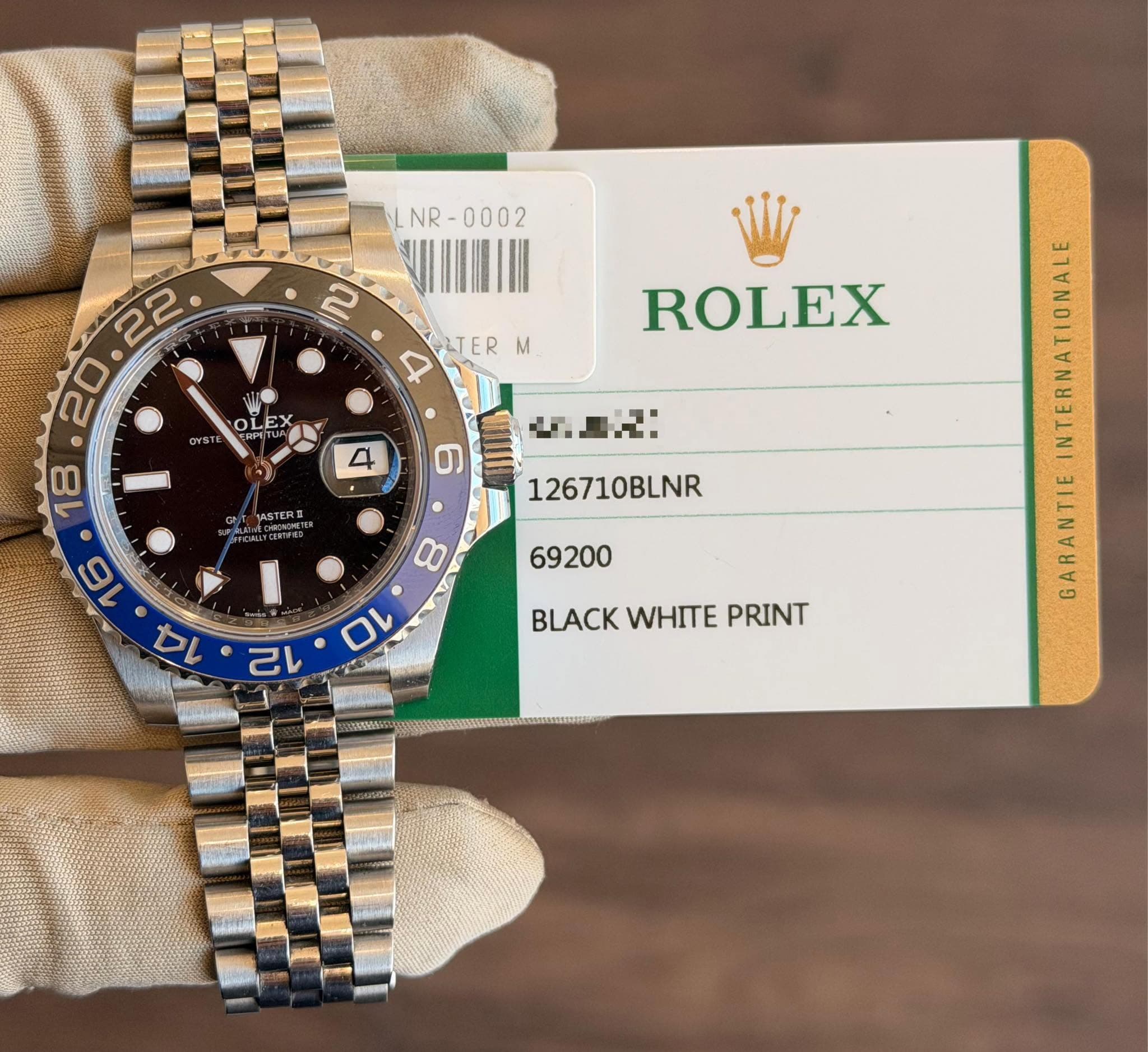 May be an image of wrist watch and text that says 'NR NR- R LTER M OI OLE ት ROLEX ASTER N 126710BLNR איל BLACK WHITE PRINT GARANTIE'