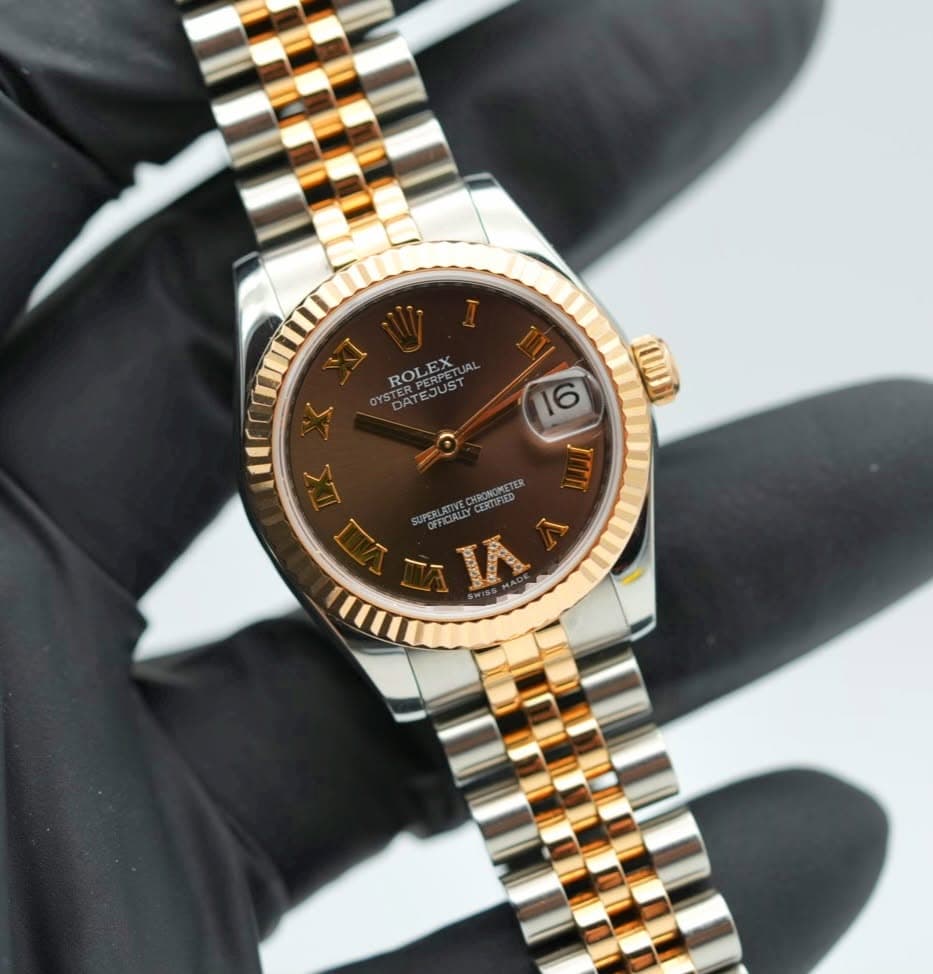 May be an image of wrist watch and text